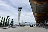 Kontrolltårnet ved Oslo lufthavn Gardermoen ved siden av terminalinngangen og en tom oppkjørsel.