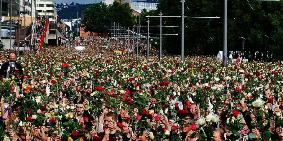 KJÆRLIGHET: Folk løfter rosene i været under markeringen på Rådhusplassen i Oslo. De minnes ofrene for terror-aksjonen i Oslo og på Utøya fredag 22. juli. De vil vise at vi står sammen for demokratiet.