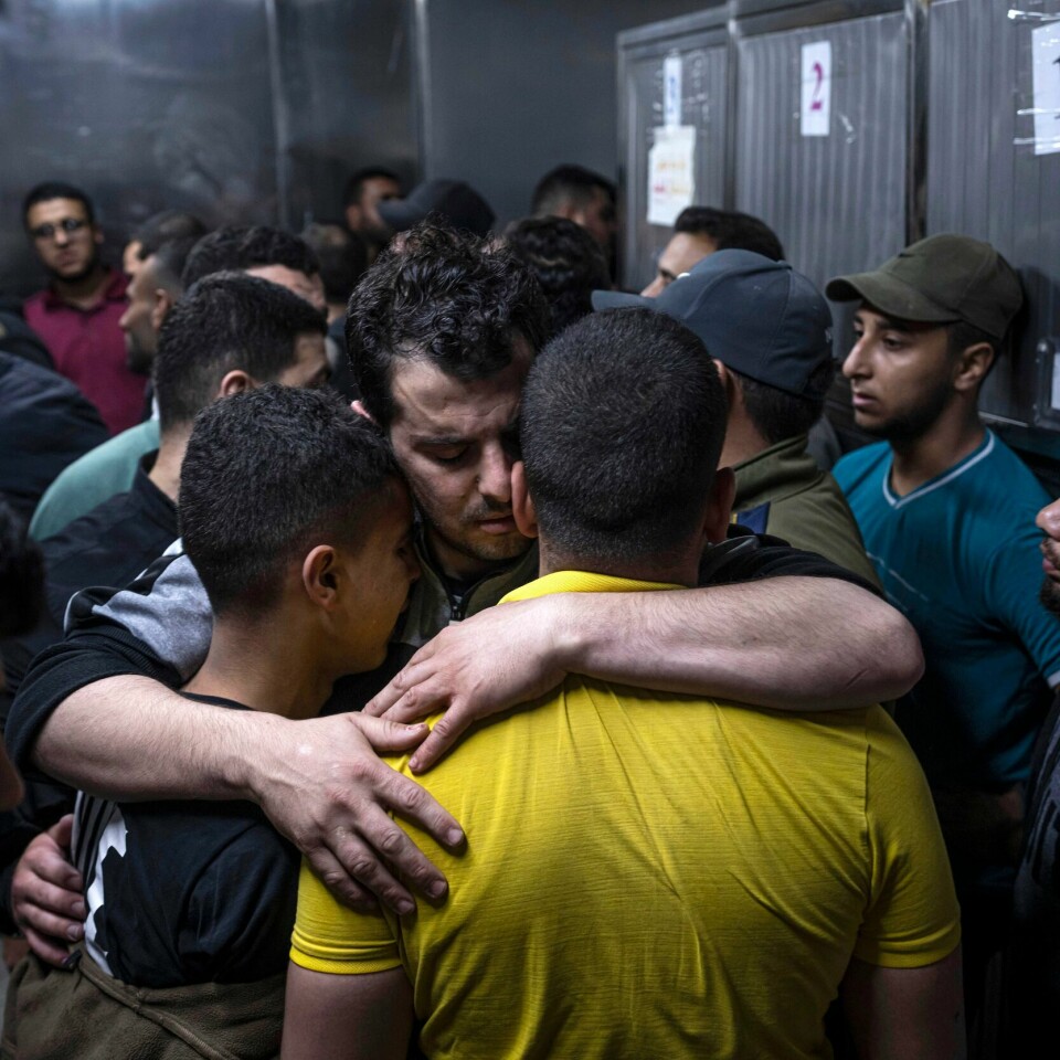 GAZA: Sørgende mennesker trøster hverandre ved et sykehus i Gaza By. Bildet viser sørgende mennsker som forsøker å trøste hverandre ved et sykehus i Gaza By.