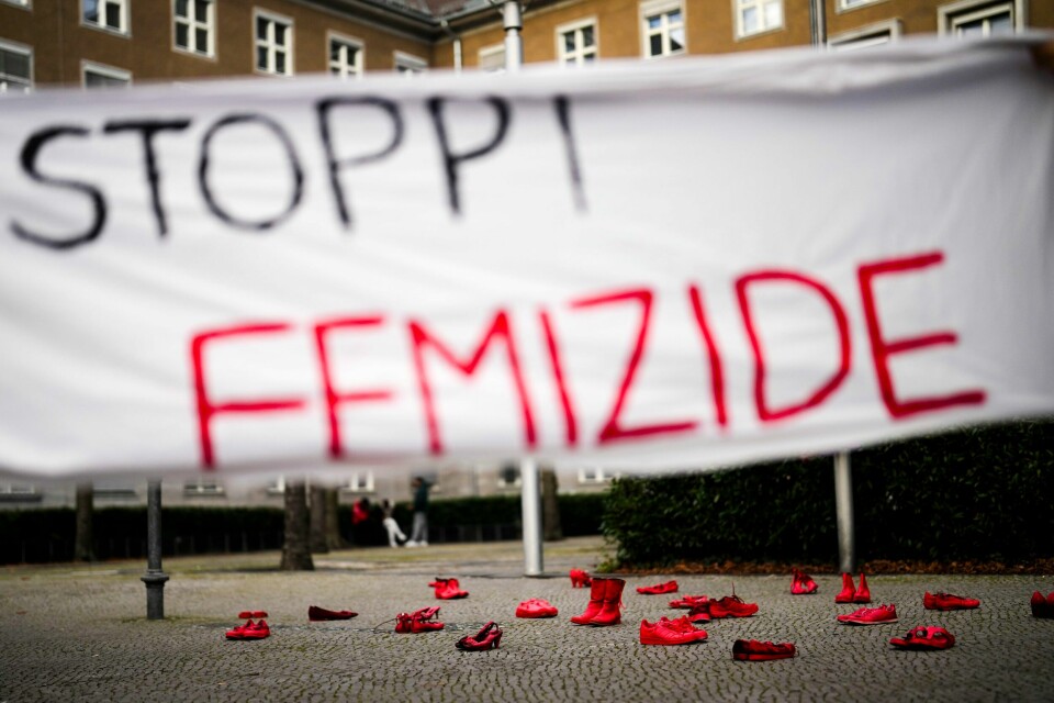 VOLD: Land over hele verden markerer den internasjonale dagen for å stoppe vold mot kvinner. I forbindelse med en aksjon mot kjønnsbasert vold i Berlin ble det plassert ut røde sko bak et banner der det stor «stopp kvinnedrap». Foto: Markus Schreiber / AP / NTB