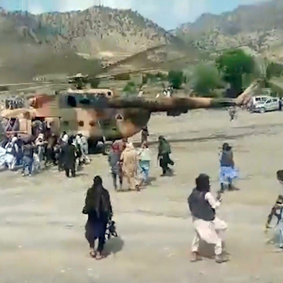 HENTET: Folk blir hentet og fløyet ut fra området der jordskjelvet var. Bildet er av folk som står rundt et helikopter. Det skal frakte folk bort fra jordskjelvområdet.