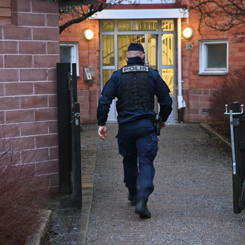 URO: Det har vært mye vold i Stockholm de siste ukene. Politiet skal være urolige for at det kan skje flere hendelser i tiden framover, skriver Aftonbladet. Bildet er av en svensk politimann som går mot en murbygning. Bildet er fra en av flere hendelser med eksplosjoner og skytinger i Stockholm de siste ukene. Arkivfoto: Claudio Bresciani / TT / Reuters / NTB