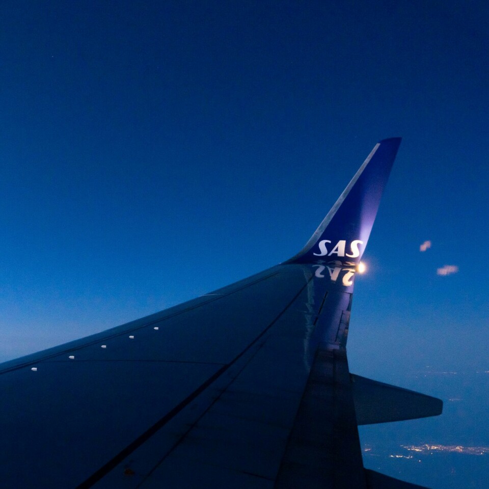 MANGE: Det er anslag om at en SAS-streik kan få følger rundt 250 flyturer og 45.000 reisende hver eneste dag den pågår. 900 piloter er klare for streik. Foto: Erik Johansen / NTB Bildet er av vingen på et SAS-fly. Bildet er tatt fra innsiden av flyet mens det er i luften. Det er SAS-logo på vingen. Foto: Erik Johansen / NTB