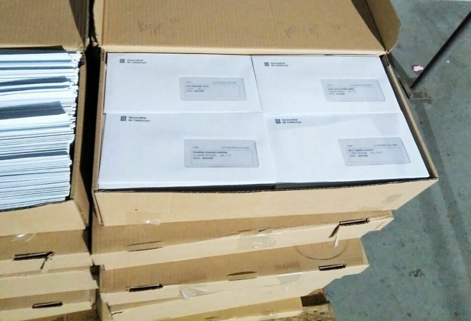 TATT: Politiet i Spania forsøker å stanse valget. Det er ulovlig, sier de. Stemmesedler blir tatt. Bildet viser en stabel av stemmesedler.