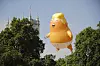 A giant balloon inflated by activists depicting US President Donald Trump as an orange baby is seen during a demonstration against Trump's visit to the UK in Parliament Square in London on July 13, 2018.US President Donald Trump launched an extraordinary attack on Prime Minister Theresa May's Brexit strategy, plunging the transatlantic 'special relationship' to a new low as they prepared to meet Friday on the second day of his tumultuous trip to Britain. / AFP PHOTO / Tolga AKMEN