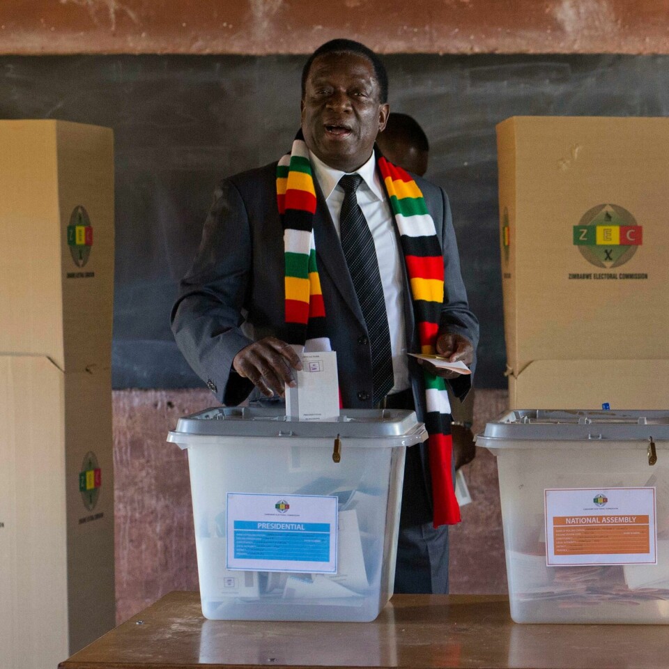 Zimbabwean President Emmerson Mnangagwa casts his vote for the presidential elections at the Sherwood Primary School in Kwekwe, Zimbabwe, Monday July 30, 2018. The vote will be a first for the southern African nation following a military takeover and the ousting of former longterm leader Robert Mugabe. (AP Photo/Jerome Delay)