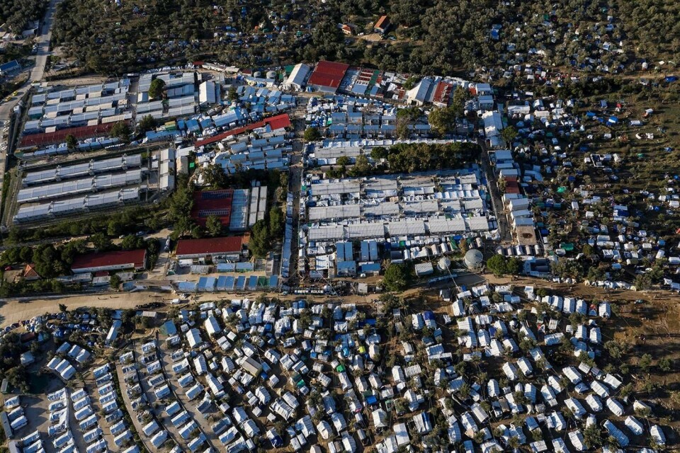 (FILES) This file photo taken on December 1, 2019, shows an aerial view of the official refugee camp of Moria, and the makeshift camp around it, on the Greek Aegean island of Lesbos. - Europe in 2015 suffered its worst refugee crisis since World War II, when over one million people fled to the continent. (Photo by ARIS MESSINIS / AFP)