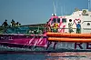 People stand on the deck of the Louise Michel rescue vessel, a French patrol boat currently manned by activists and funded by the renowned artist Banksy in the Central Mediterranean sea, at 50 miles south from Lampedusa, Friday, Aug. 28, 2020. British artist Banksy has financed a boat to rescue refugees attempting to reach Europe from north Africa. (AP Photo/Santi Palacios)