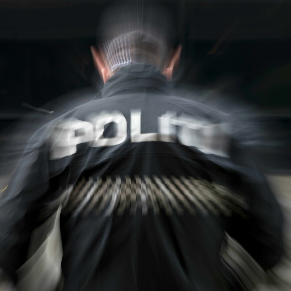 PÅGREP MANN: Politiet pågrep en mann tirsdag. Det skjedde etter at en annen mann havnet i vannet i Moss. Bildet viser en politibetjent med ryggen til. Foto: NTB