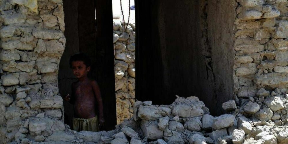 VENTER: : En gutt står i det som var familiens hus. Det ble ødelagt av et jordskjelv tirsdag. Jordskjelvet ødela mange hus i Baluchistan-provinsen i Pakistan.