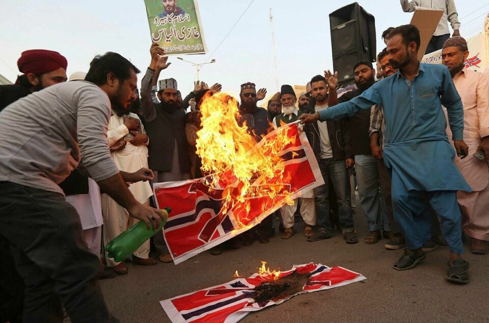 Pakistani protesters burn representations of Norwegian flag to condemn the desecration of the Muslim Holy book Quran in the Norwegian city of Kristiansand, in Karachi, Pakistan, Tuesday, Nov. 26, 2019. Pakistan's Foreign Ministry said Saturday it had summoned Norway's ambassador to convey the deep concern of the government and Pakistani people over the recent burning of the Quran by a Norwegian man that was caught on video. (AP Photo/Fareed Khan)