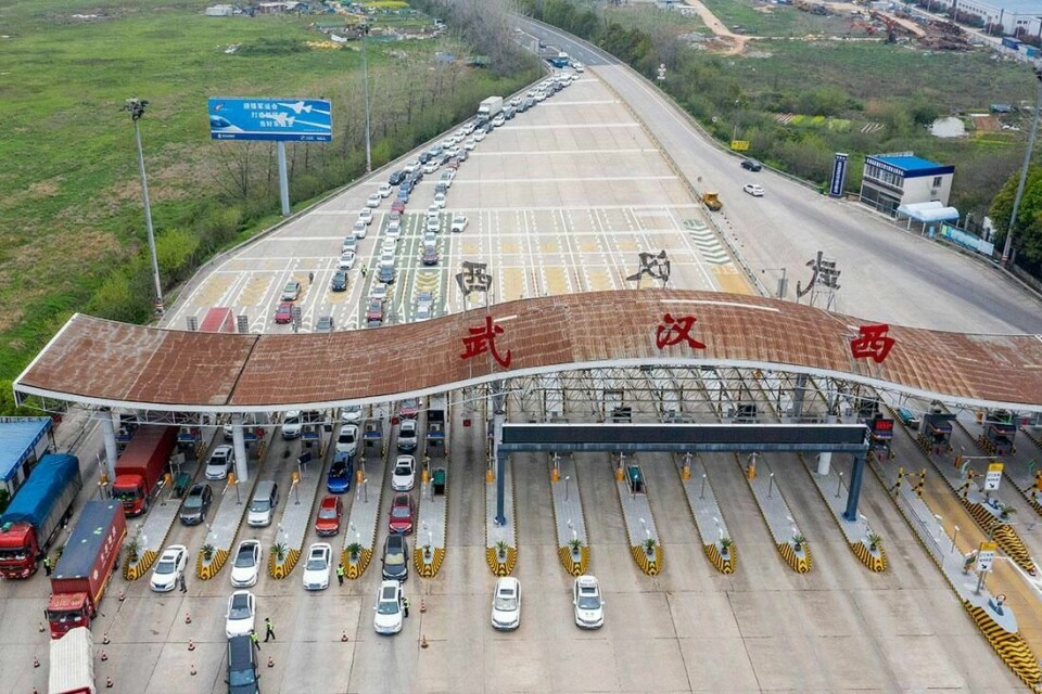 KØ: Biler står i kø for å komme inn i Wuhan. Noen veier inn til den kinesiske byen er nå åpnet. I resten av Hubei får friske nå reise fritt. Mange drar nå ut av provinsen.